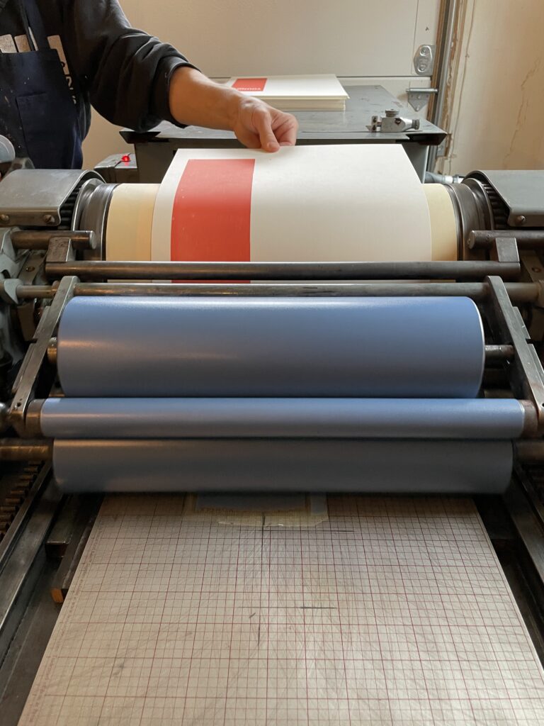 Feeding paper into a Vandercook Universal 1 press